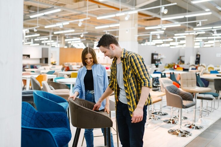 Happy couple selecting wholesale business furniture in a showroom, wholesale business furniture options for office setup