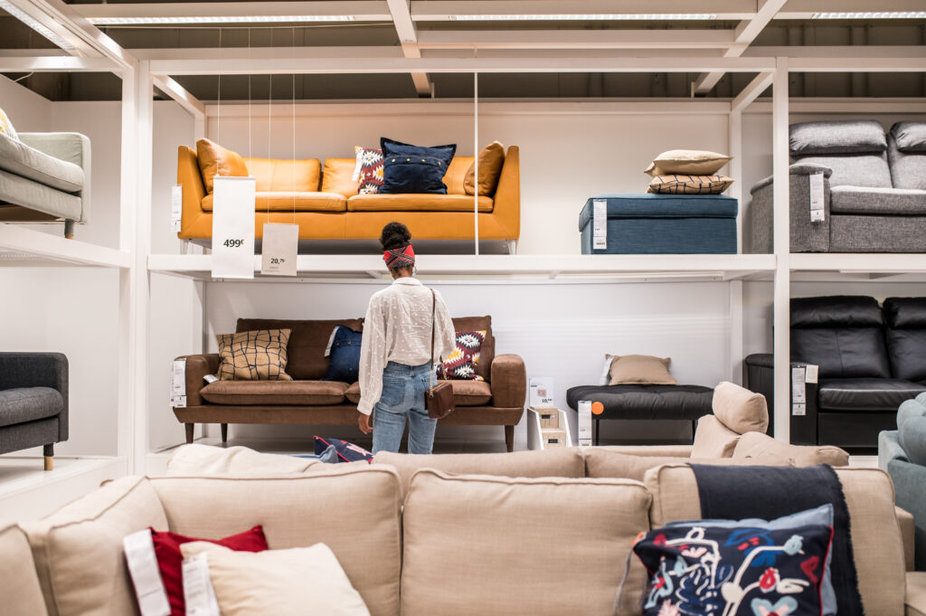 female customer selecting office chairs at a business furnishings display